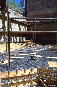 The reinforced concrete mat will vary in thickness from 4 to 8 feet across the building footprint.