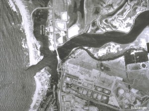 This 1987 aerial photo is of the same area. Comparisons of this photo with the 1952 photo (and other photos) show shoreline variations as well as old and new constructed facilities (e.g., see the new docks in the southern inner harbor). The shoreline variations helped identify locations of very young alluvial deposits, which correlated with some of the more extensive liquefaction damage.