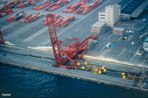 A closer view of the collapsed crane (also visible in the previous photo). The quay wall has displaced outwards and a graben (depression) has formed behind it. The cranes had their legs spread apart, causing buckling and yielding, and collapse in this case. A series of yellow trucks were caught in the graben. 