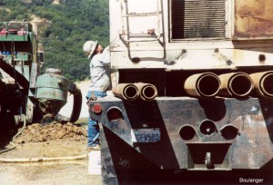 Different size casings are available, as shown on the supply truck. The casing is double-tubed with an annulus between the inner and outer tubes. During "open bit" drilling (i.e., the end is open), high-pressure air is forced down the outer annulus and returned up the inner tube. The returning air carries soil cuttings up to the ground surface.