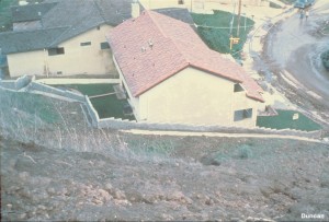 View of a wall and the protected house from uphill. (Photo by Hollingsworth and Kovacs).