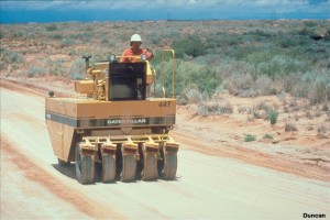 Here a pneumatic rubber-tired roller is compacting clay soil. Clays are more difficult to compact than sands and gravels, because they must be brought to the right range of water content before they can be compacted to high densities. Static pressure, as exerted by the wheels of this rubber-tired roller, compacts clays well. (Photo by Caterpillar).