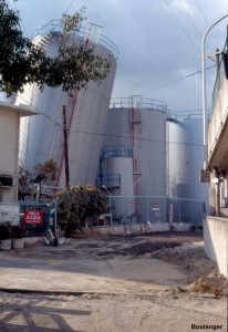 This tank farm was located on reclaimed land along the waterfront. The cohesionless fill materials liquefied during the earthquake, and many tanks experienced excessive settlements or bearing failures.