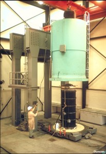 The triaxial specimen is 3 feet in diameter by 7.5 feet high. The chamber, which is being lowered over the test specimen, is designed for cell pressures of 750 psi. Materials with particles as large as 6 inches can be tested in this device.
