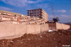 About 2 m of right-lateral slip occurred at this apartment complex in Kullar, as evidenced by the offset in the concrete wall. The rupture passed directly beneath the collapsed building. However, six other similar buildings in this complex also completely collapsed due to shaking alone.
