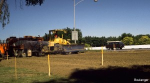 The operators of the water truck and cat sequence their passes across the site. A grader was later used for final shaping of the roadway surface.