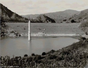 This is a view of the upstream face of the dam the day before the slide in 1918. The dam is still being raised at this time. The upstream and downstream shells act as berms that retain an inner pool of hydraulic fill materials. These hydraulically placed materials are still very weak (i.e., consolidating) at this time.